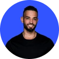 Profile photo of Andrew Raso, founder and CEO of Online Marketing Gurus, smiling against a bright blue background.
