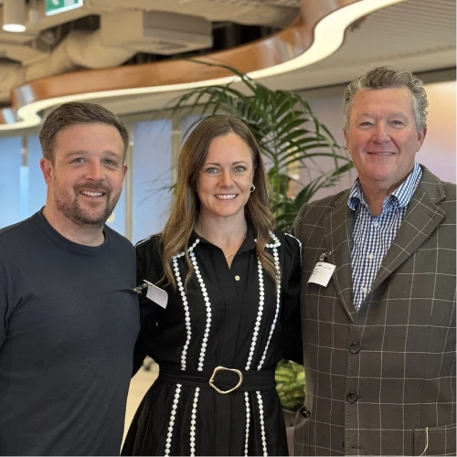 JP, CMO of Online Marketing Gurus, with members of the Microsoft Ads leadership team, smiling together at a Microsoft office event.