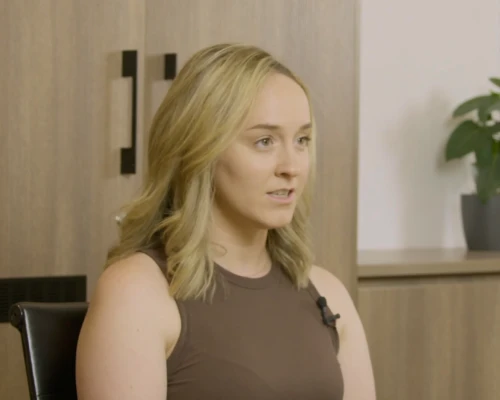 A representative from PMC, a real estate client of Online Marketing Gurus, being interviewed on camera in a modern office setting.