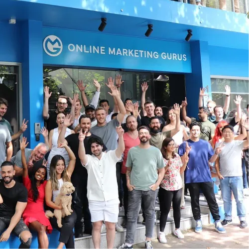 OMG Sydney team celebrating in front of Online Marketing Gurus Sydney office