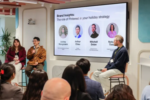 Mitchell Dolan from Online Marketing Gurus speaking on a Pinterest panel titled "Brand Insights: The role of Pinterest in your holiday strategy", alongside fellow panellists Ashley Wangmann, Arthur Chau, and Natalie Tinto.