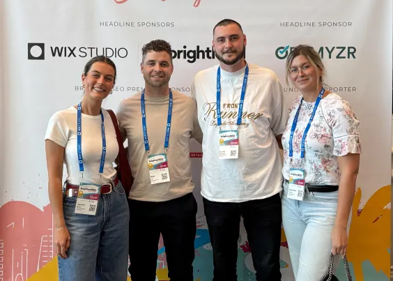 OMG SEO team at an industry conference with Wix Studio and BrightLocal sponsor branding, 2025