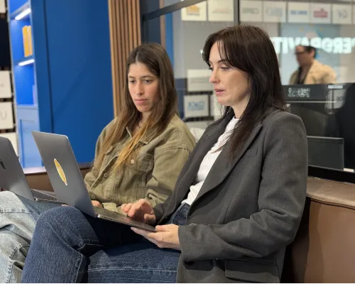 OMG paid media strategists working on a LinkedIn Ads campaign together on laptops