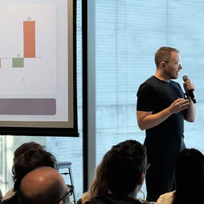 David, OMG's Head of Paid Media, presenting campaign performance data to the team