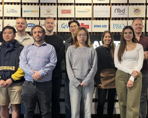 The OMG Meta ads specialist team standing in front of a wall of client brand logos
