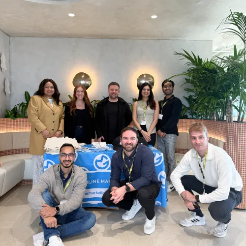 The OMG team at the Pinterest 2025 event standing behind the branded welcome desk