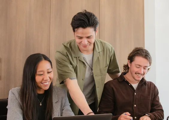 OMG team collaborating on foundational strategy work at a laptop