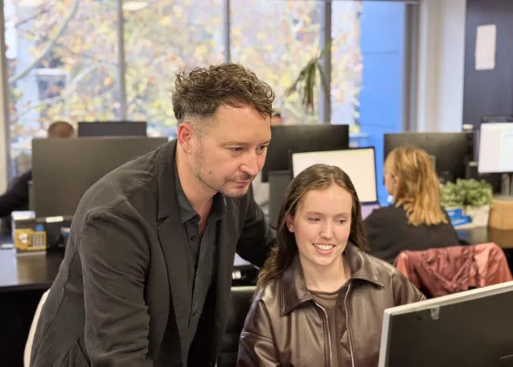 OMG strategist and analyst reviewing research findings on screen