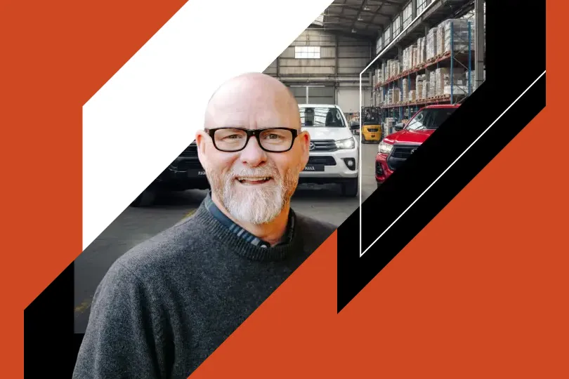 Synerfin Asset Finance client portrait against a warehouse and vehicle fleet backdrop for the OMG web design case study