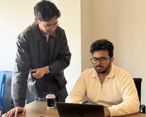 OMG paid media specialists reviewing an Ads campaign setup on a laptop