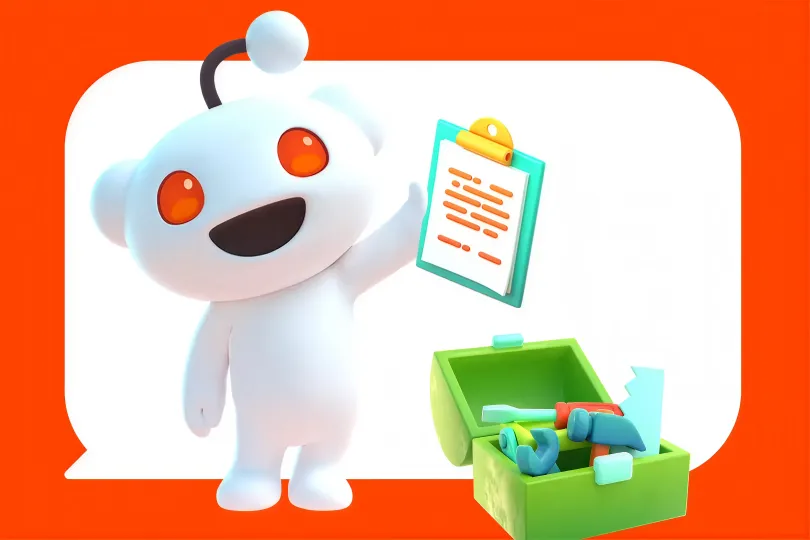 3D Reddit mascot holding a clipboard beside a toolbox