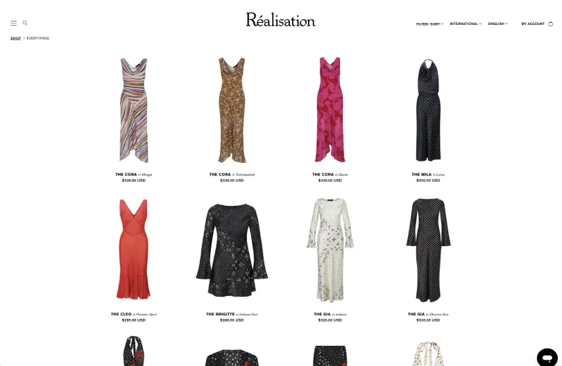 Réalisation Par online store showing a grid of printed silk dresses and separates with USD pricing