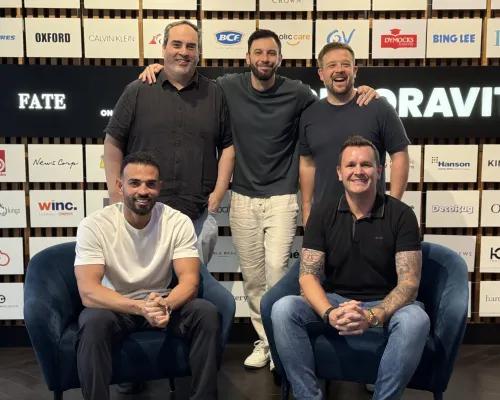 OMG's Australia and US leadership team in front of a wall of client brand logos.