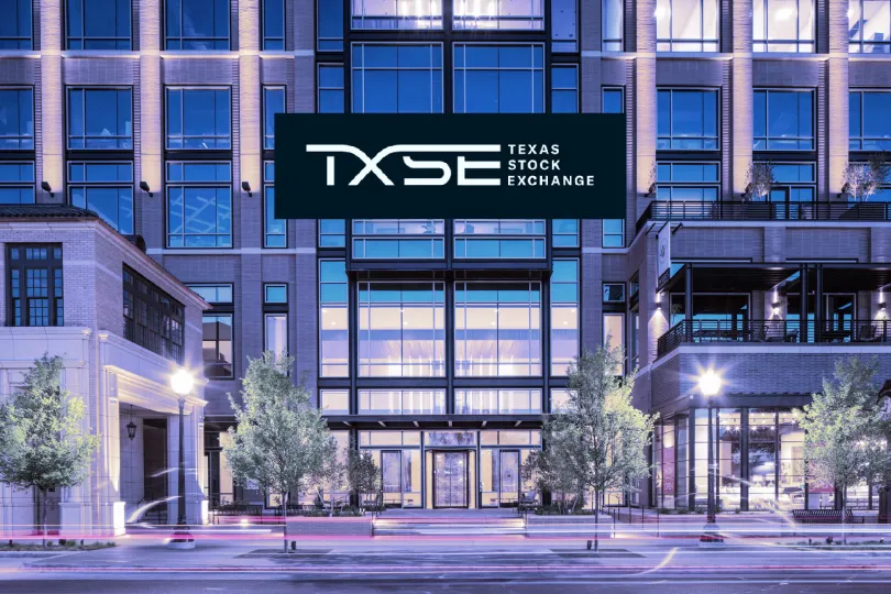 Texas Stock Exchange sign inside an office lobby with a person's silhouette reflected in the glass